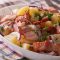 Savory and tangy warm german potato salad with crispy bacon and a flavorful vinegar-based dressing